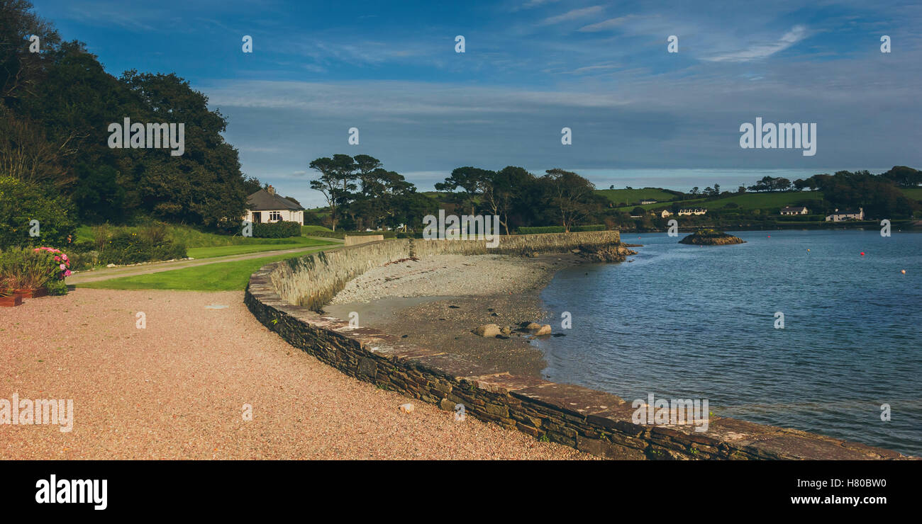 A beautiful crescent shaped shoreline on a lake flanked by a manicured garden on the edge of an estate. October 2016, Ireland. Stock Photo