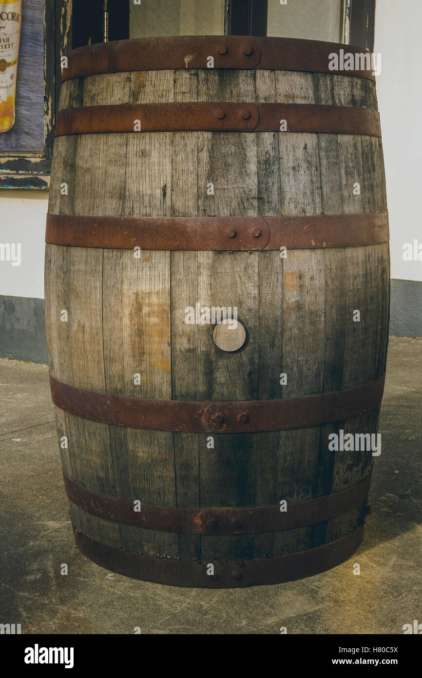 A barrel that has been repurposed in to a standing table at a