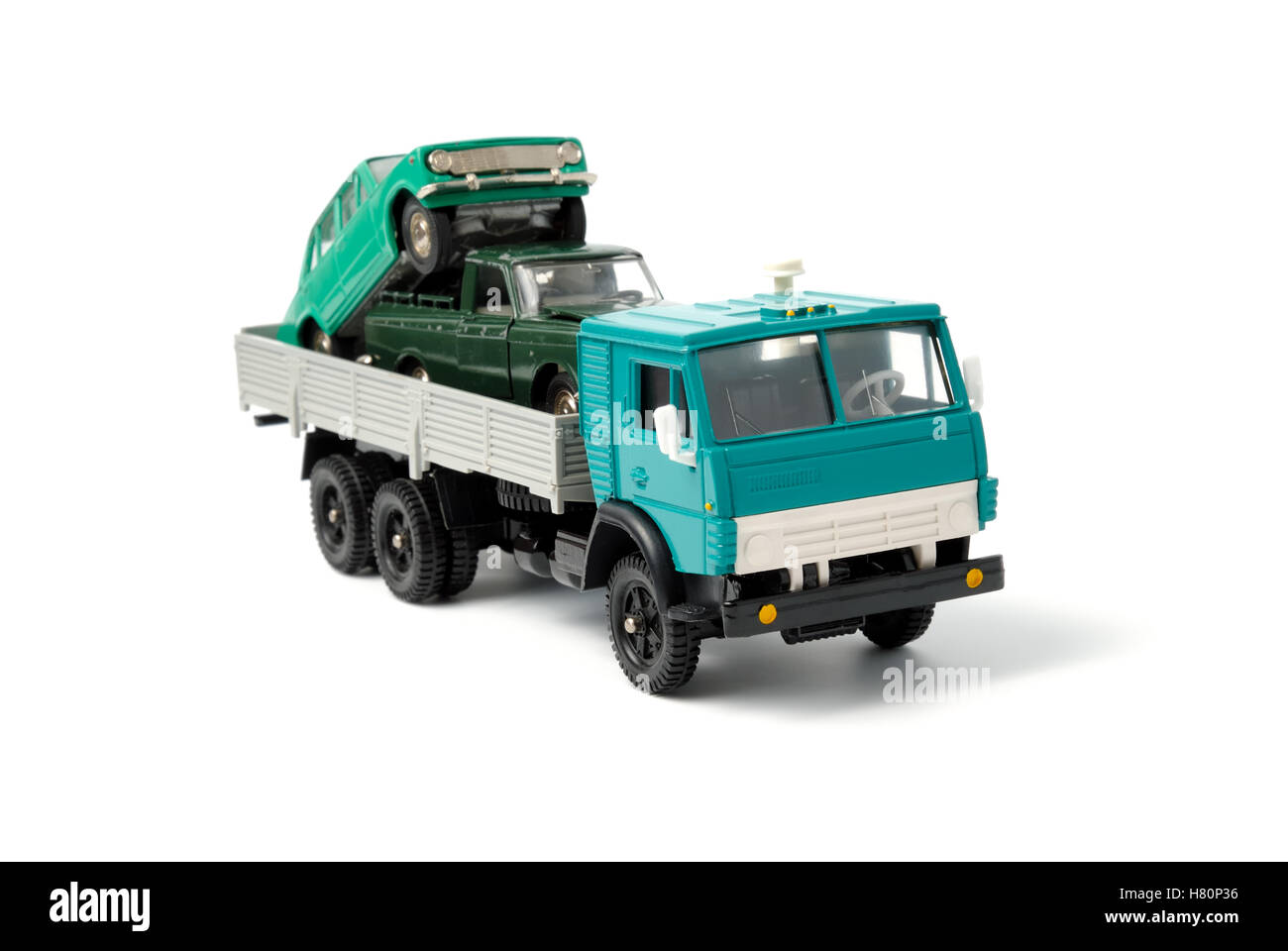 Toy cars in the back of toy truck on a white background Stock Photo