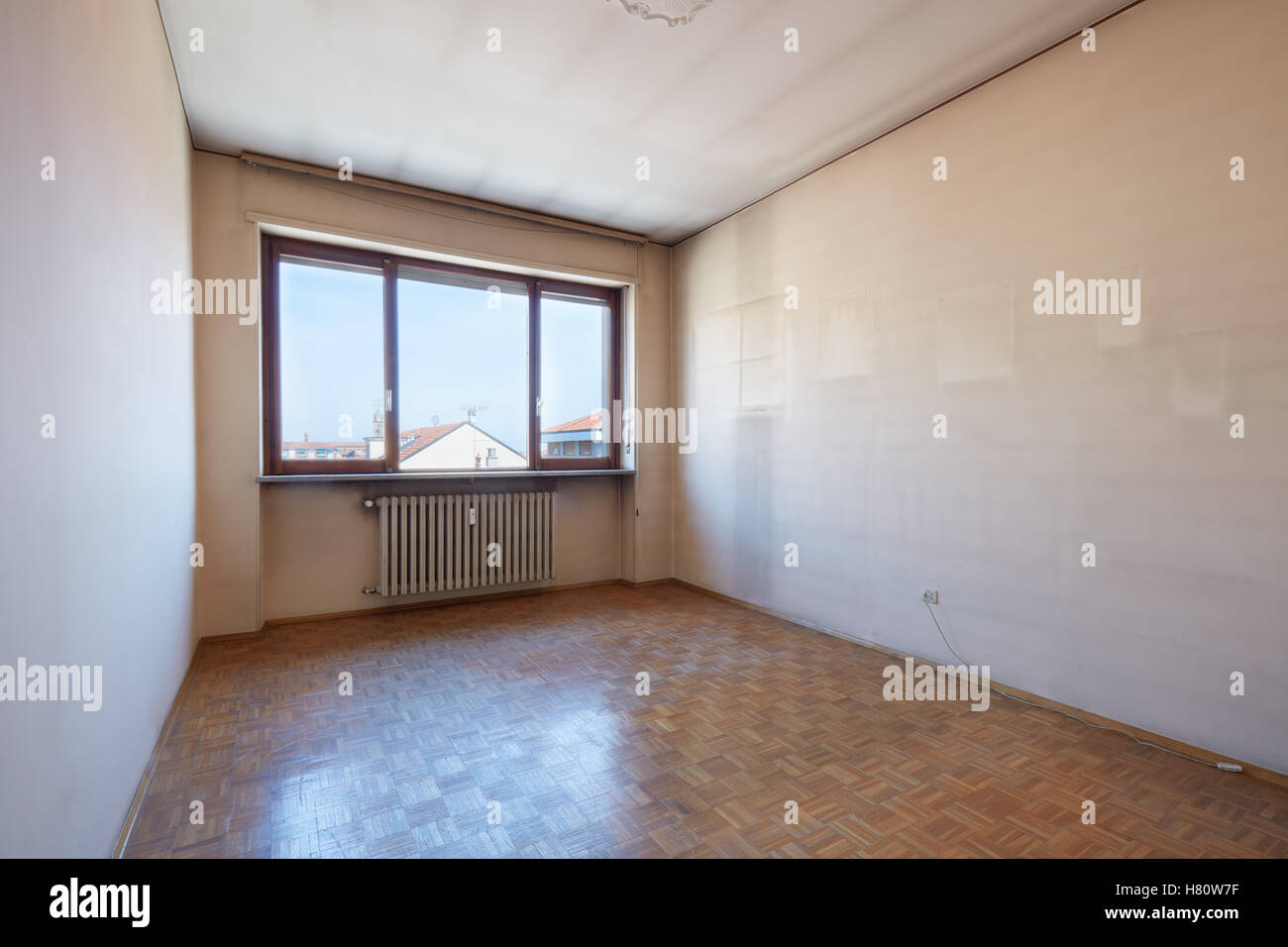 Empty room interior with wooden floor and dirty walls Stock Photo