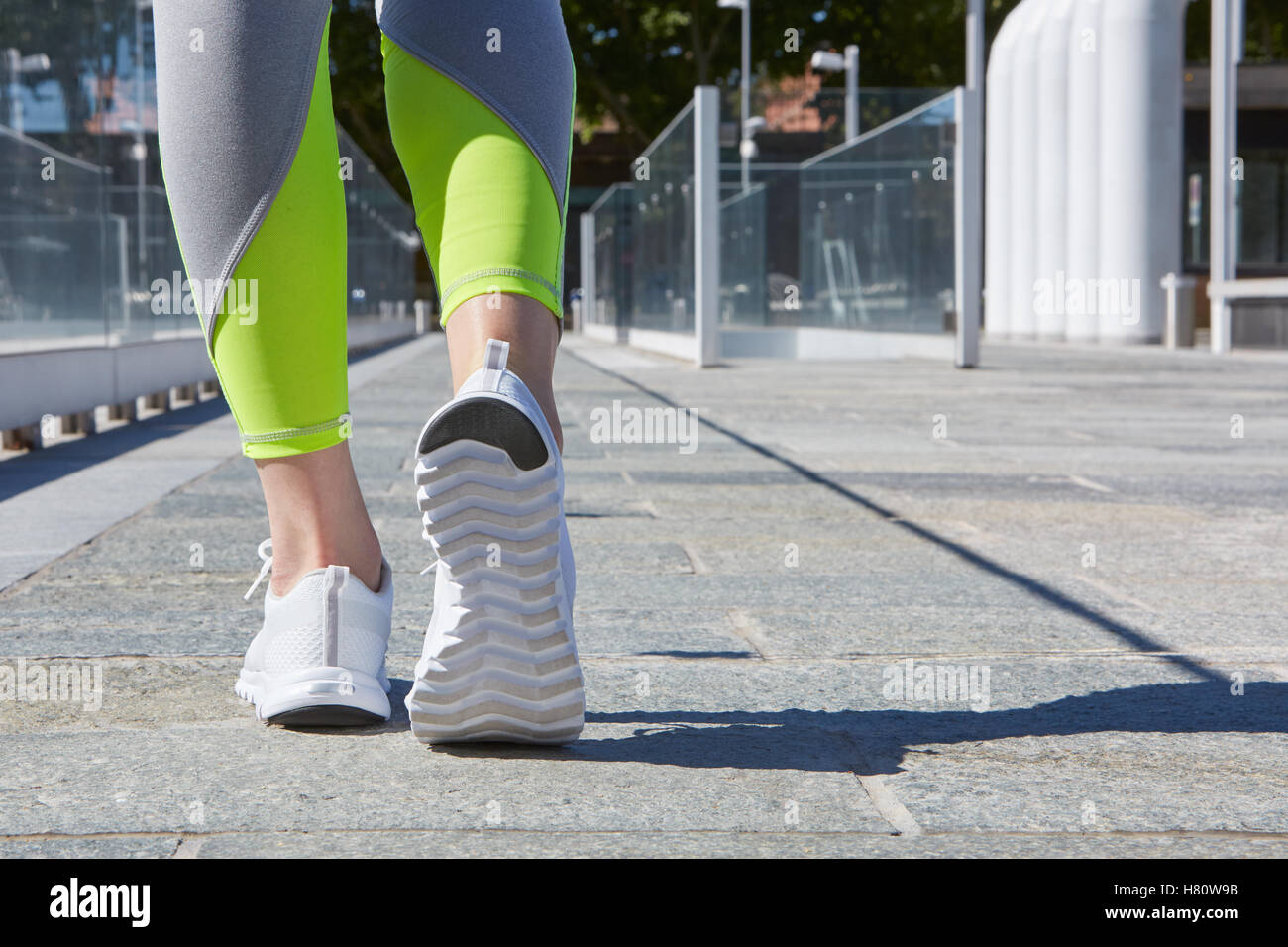 Woman ready to run outdoor in a modern city in a sunny day Stock Photo
