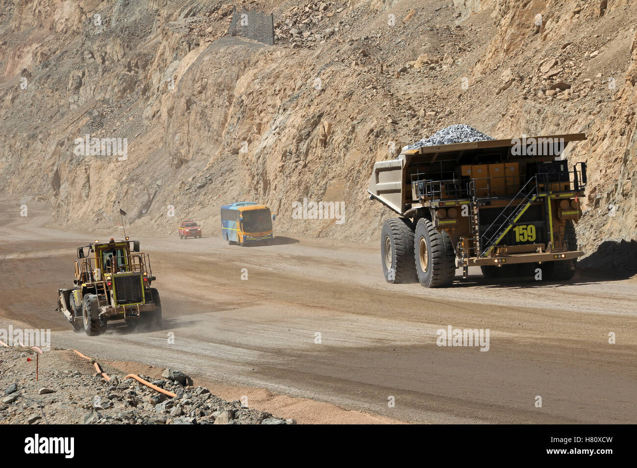 Size comparison of the huge trucks at Chuquicamata, the world's biggest open pit copper mine with its trucks working, near Calama, Chile Stock Photo