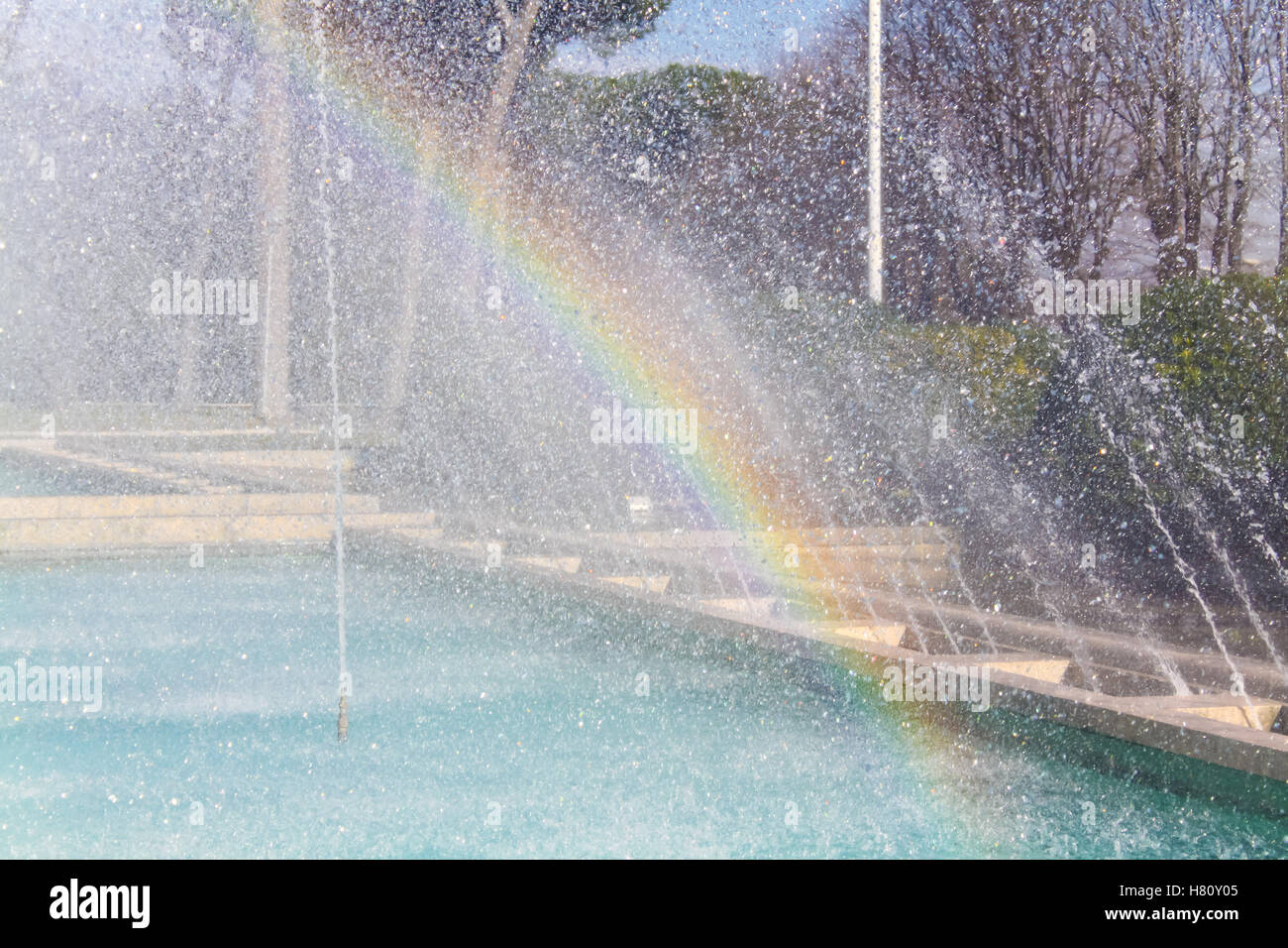 Rainbow effect on waterdrops fountain Stock Photo