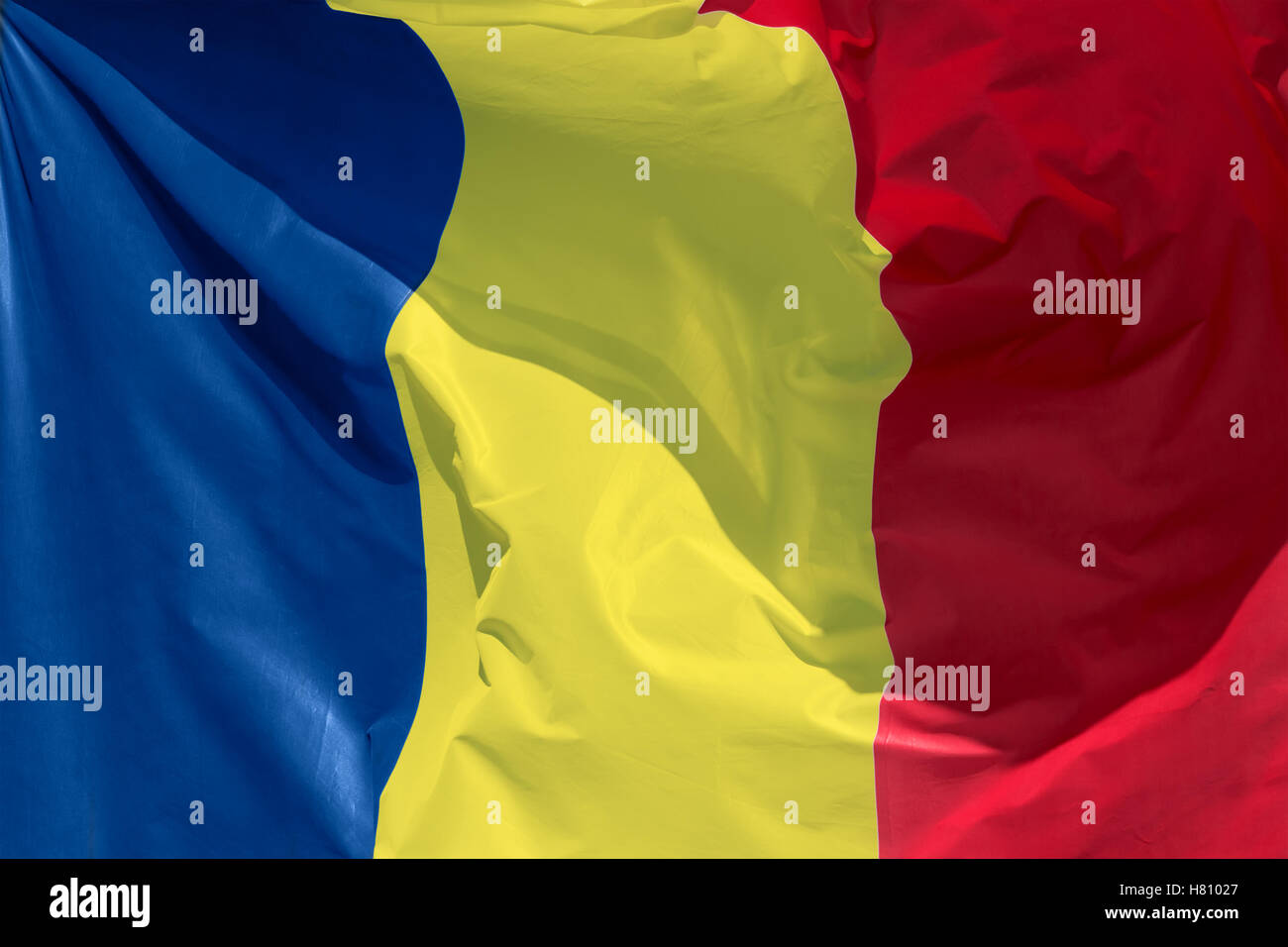 full framed romanian flag floating in the wind exact colors Stock Photo
