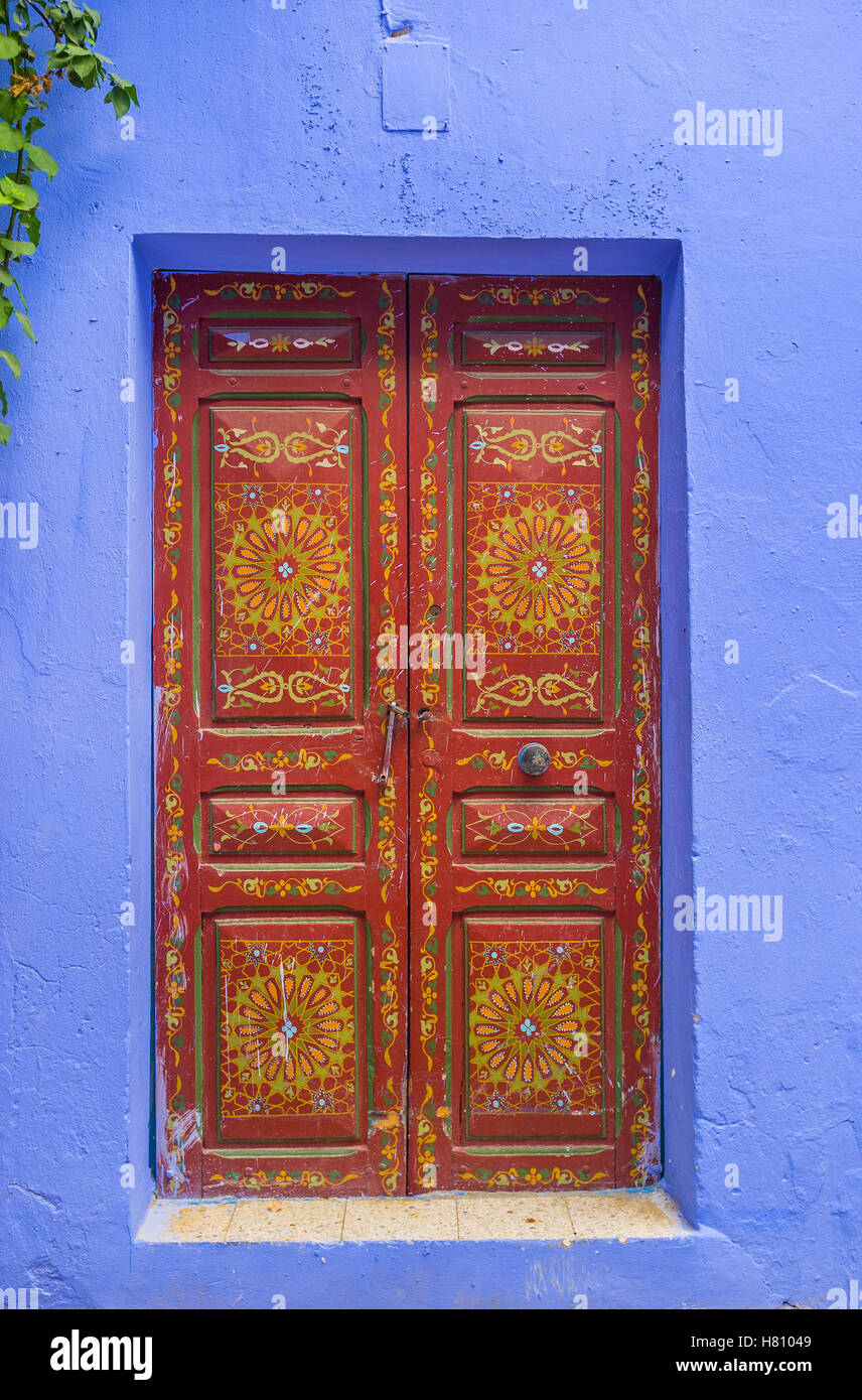 The old street in Medina with the different beautiful doors decorated with painted flowers and islamic patterns, Sousse, Tunisia Stock Photo