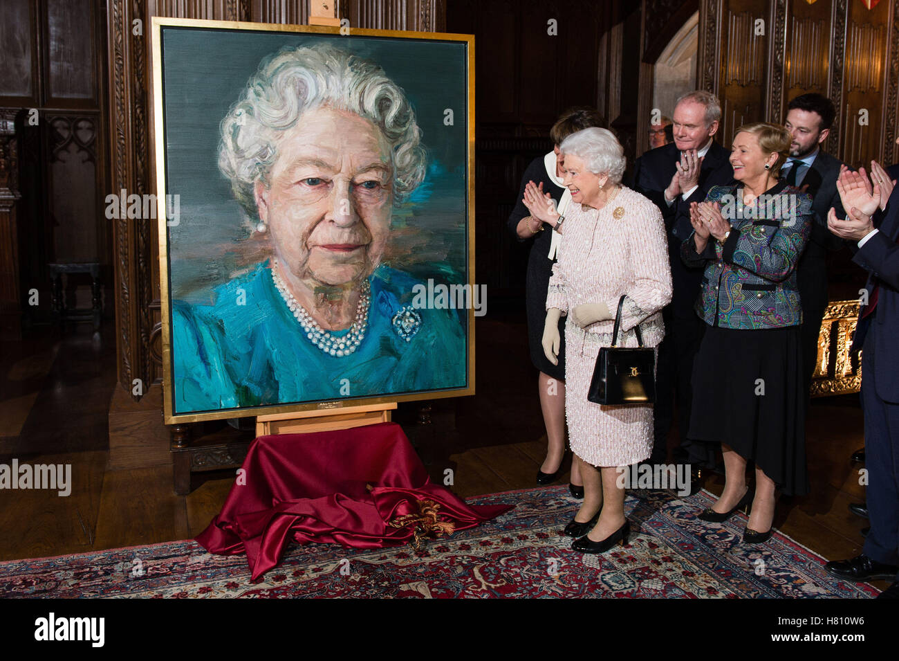 (left to right) Queen Elizabeth II, Martin McGuinness Deputy First Minister of Northern Ireland, and Frances Fitzgerald Minister of Justice and Equality Gov of Ireland at a Co-operation Ireland reception at Crosby Hall in London, during the reception the Queen unveiled a portrait of herself by artist Colin Davidson. Stock Photo