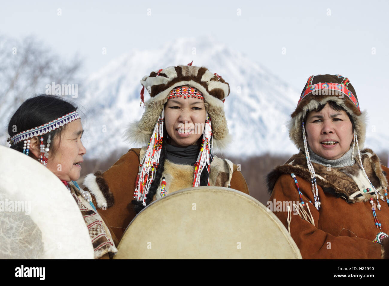 Womens dressed in the Koryak national costume with tambourines. Public