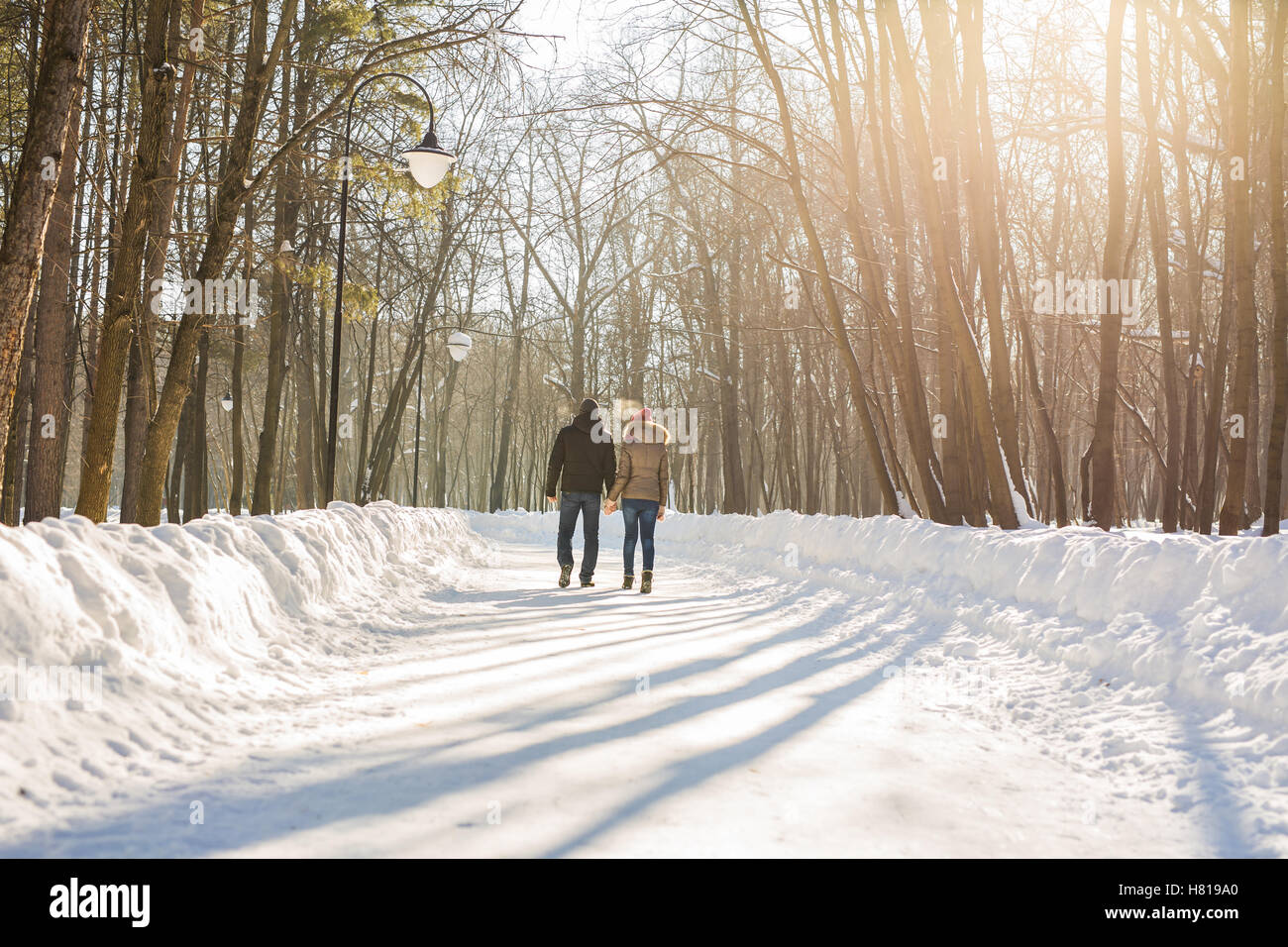 Young couple in love walking in the snowy forest Stock Photo - Alamy