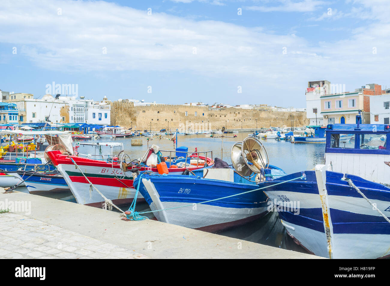 The colorful fishing boats with the Kasbah fortress on the background Stock Photo