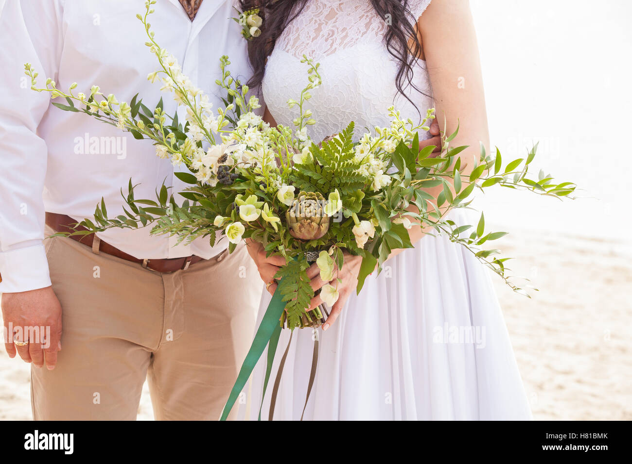 a wedding bouquet is in the hands of fiancee Stock Photo