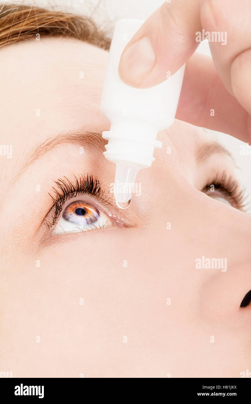 close up of female putting eye drops in Stock Photo Alamy