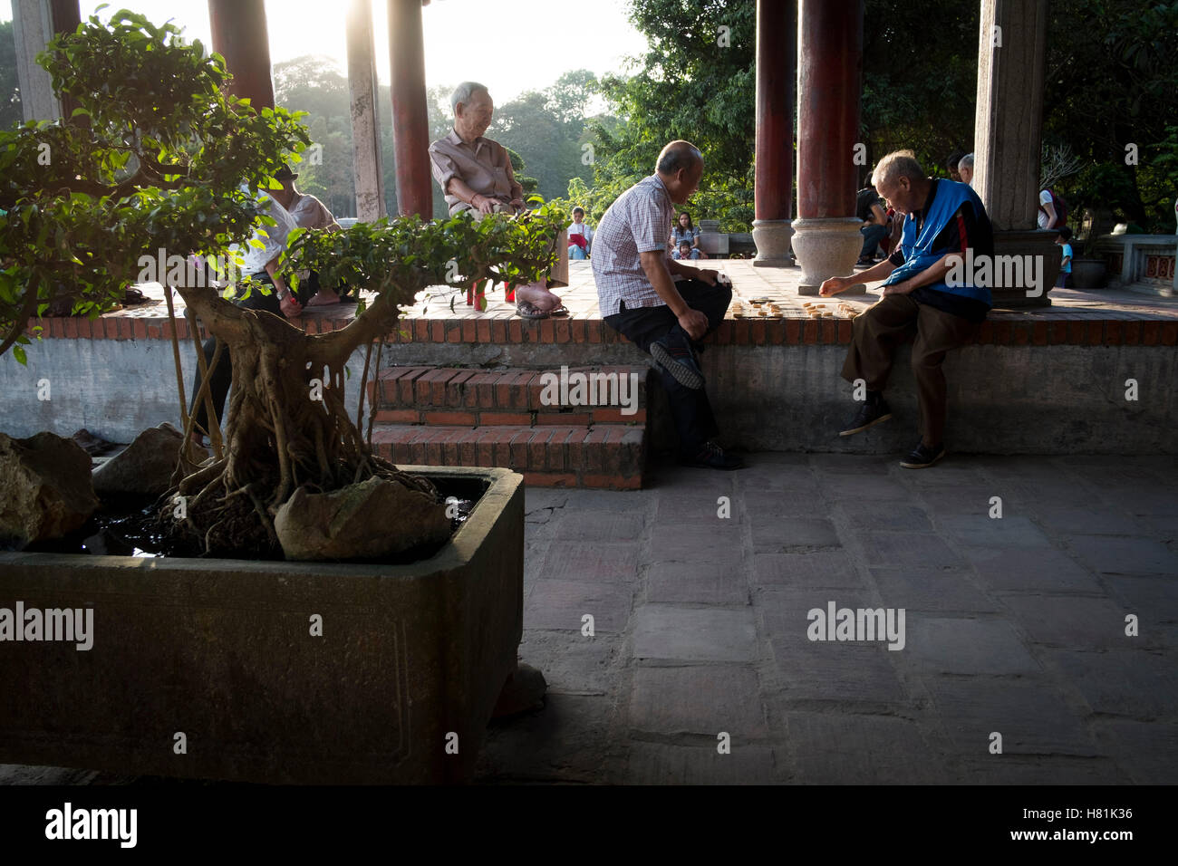 Hanoi Vietnam. Old men play a traditional board game near Ngoc Son Temple on Hoan Kiem Lake in Hanoi Stock Photo