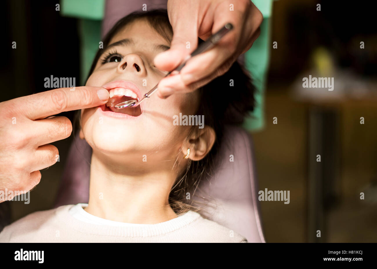 View at little girl at the dentist checkup Stock Photo