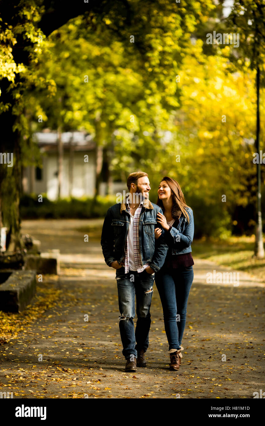 Young loving couple having a walk in the autumn park Stock Photo - Alamy