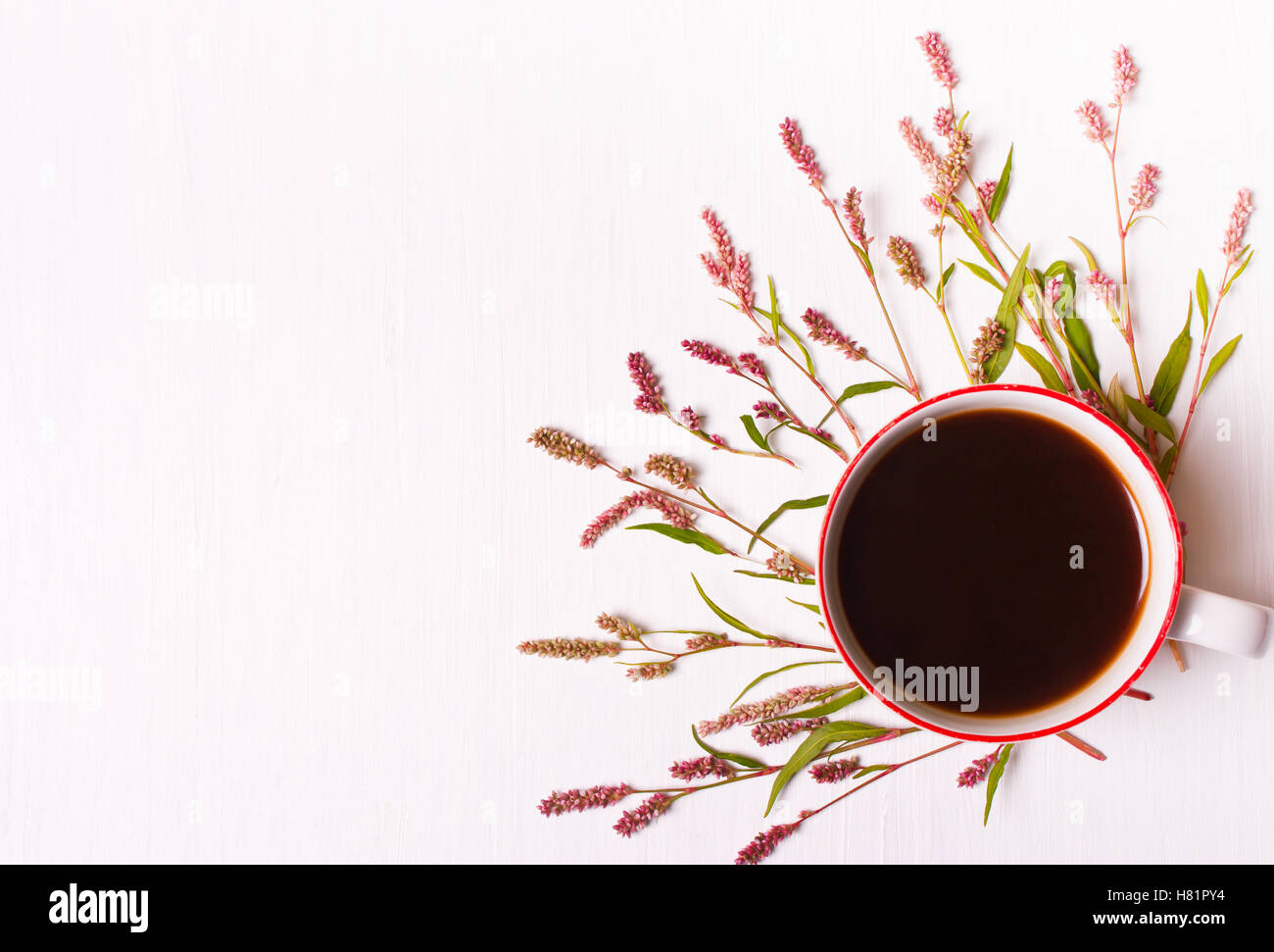 Cup of coffee with pink flowers on a white background, top view,good morning set Stock Photo
