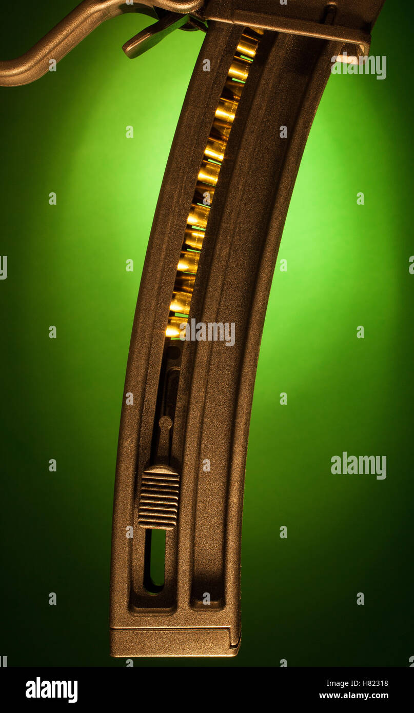 High capacity assault rifle magazine with a green background Stock Photo
