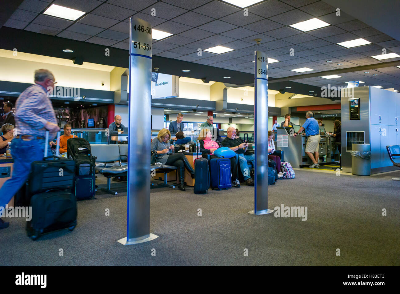 Seated travelers waiting at gate; Pittsburgh International Airport; Pittsburgh; Pennsylvania; USA Stock Photo