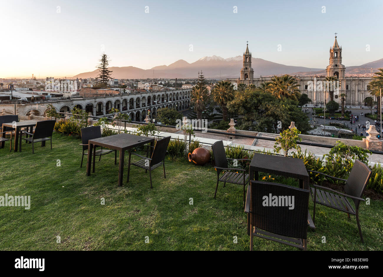 View of Arequipa cathedral, volcanoes and cafe Stock Photo