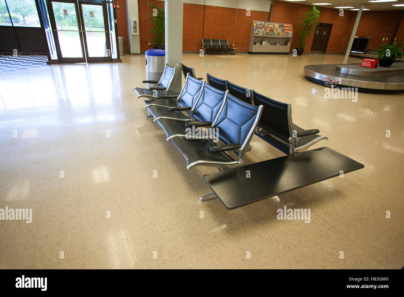 Empty seats and luggage belt at an airport Stock Photo