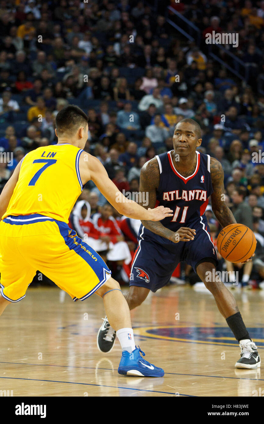February 25, 2011; Oakland, CA, USA;  Atlanta Hawks guard Jamal Crawford (11) is defended by Golden State Warriors point guard Jeremy Lin (7) during the fourth quarter at Oracle Arena. Atlanta defeated Golden State 95-79. Stock Photo