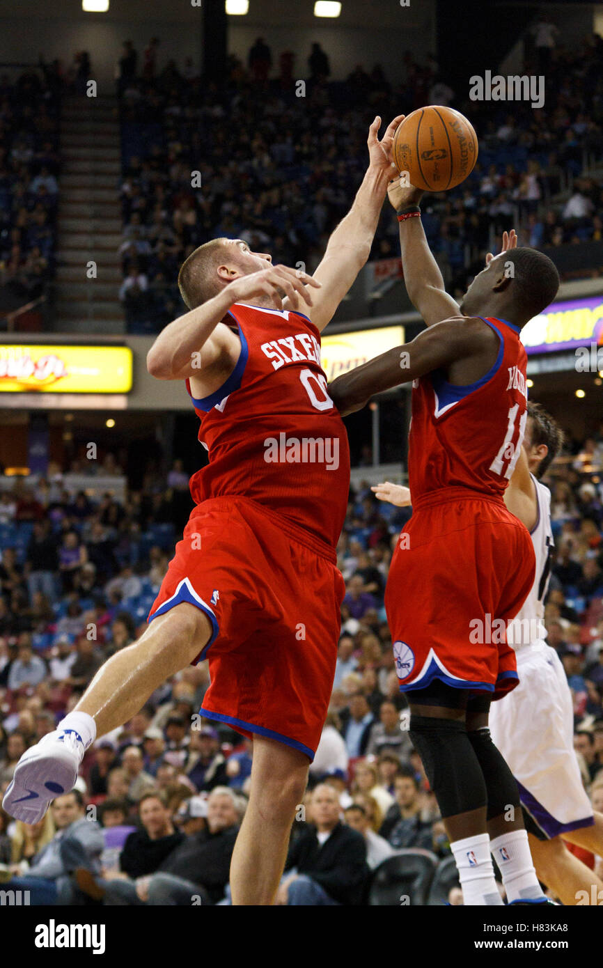 March 18, 2011; Sacramento, CA, USA;  Philadelphia 76ers center Spencer Hawes (00) and point guard Jrue Holiday (11) grab a rebound against the Sacramento Kings during the third quarter at the Power Balance Pavilion. Philadelphia defeated Sacramento 102-8 Stock Photo