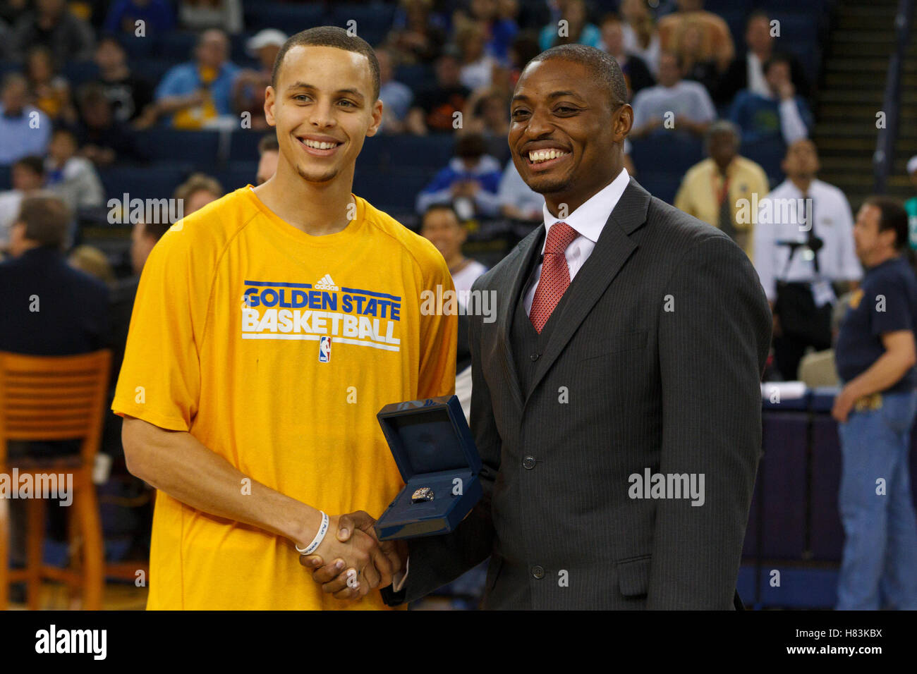 April 10, 2011; Oakland, CA, USA;  Golden State Warriors point guard Stephen Curry (left) is presented with his 2010 FIBA world championship ring by B.J. Johnson (right) before the game against the Sacramento Kings at Oracle Arena. Stock Photo