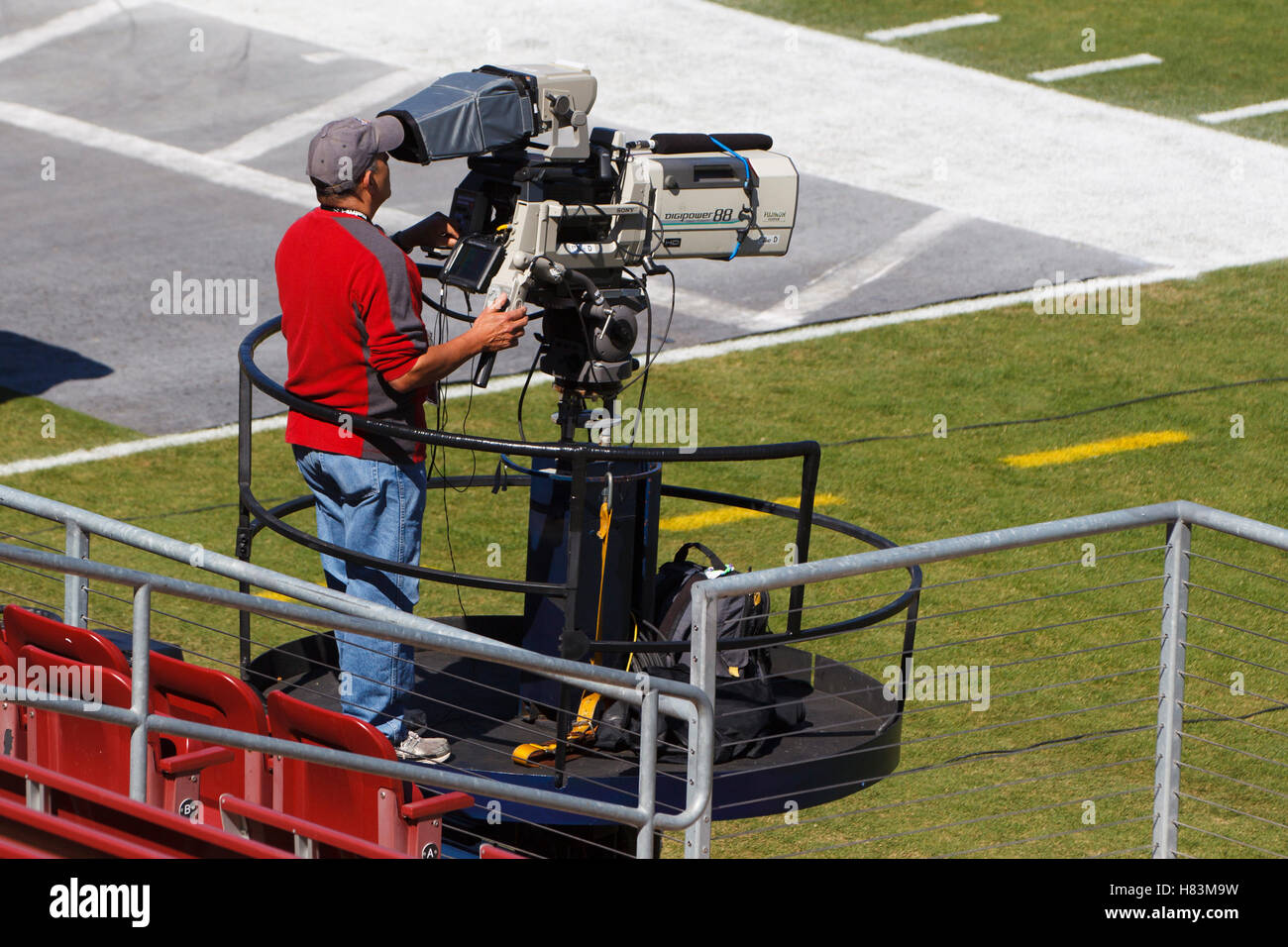 Oct 8, 2011; Stanford CA, USA;  A television cameraman on the field before the game between the Stanford Cardinal and the Colorado Buffaloes at Stanford Stadium.  Stanford defeated Colorado 48-7. Stock Photo