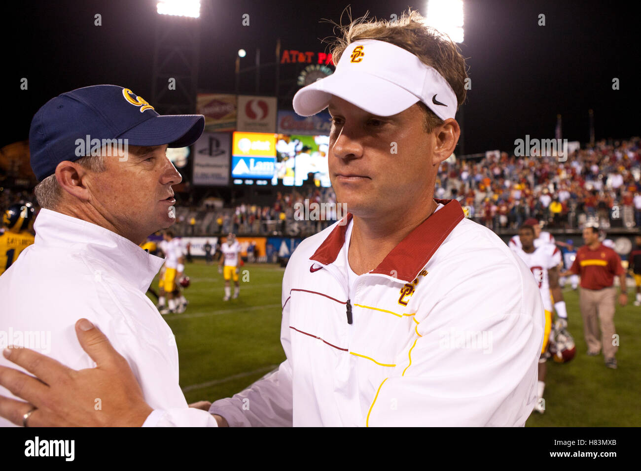 Oct 13, 2011; San Francisco CA, USA;  Southern California Trojans head coach Lane Kiffin (right) shakes hands with California Golden Bears head coach Jeff Tedford (left) after the game at AT&T Park.  Southern California defeated California 30-9. Stock Photo