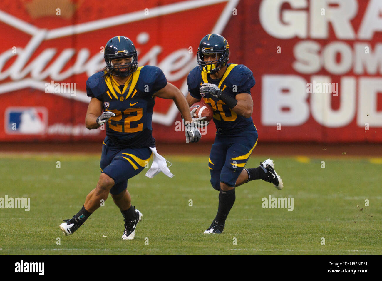 Nov 5, 2011; San Francisco CA, USA;  California Golden Bears running back Isi Sofele (20) rushes behind fullback Will Kapp (22) during the second quarter against the Washington State Cougars at AT&T Park.  California defeated Washington State 30-7. Stock Photo