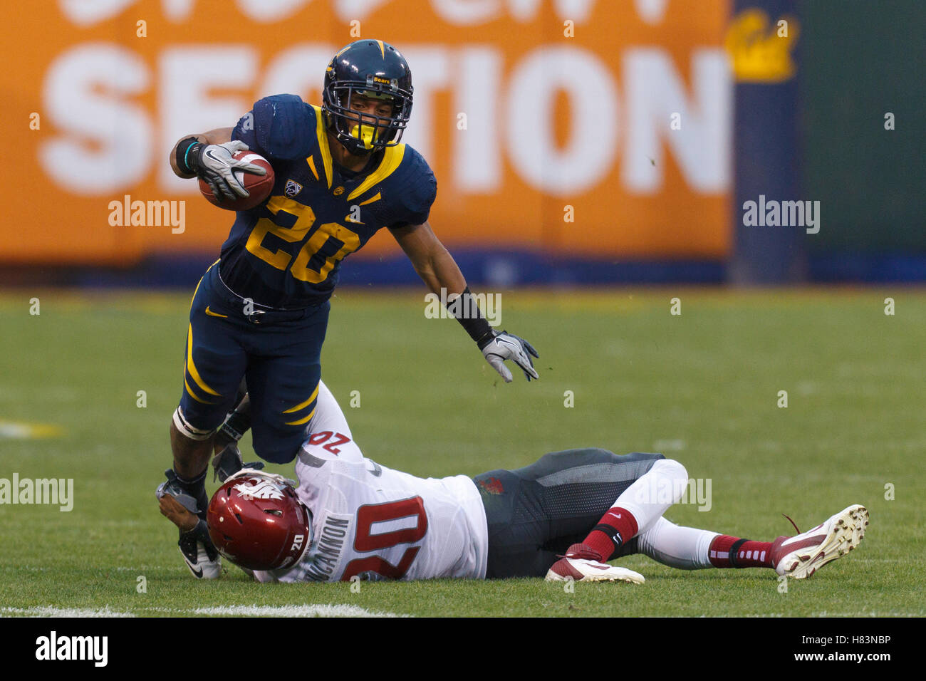 Nov 5, 2011; San Francisco CA, USA;  California Golden Bears running back Isi Sofele (20) is tackled by Washington State Cougars safety Deone Bucannon (20) during the second quarter at AT&T Park.  California defeated Washington State 30-7. Stock Photo