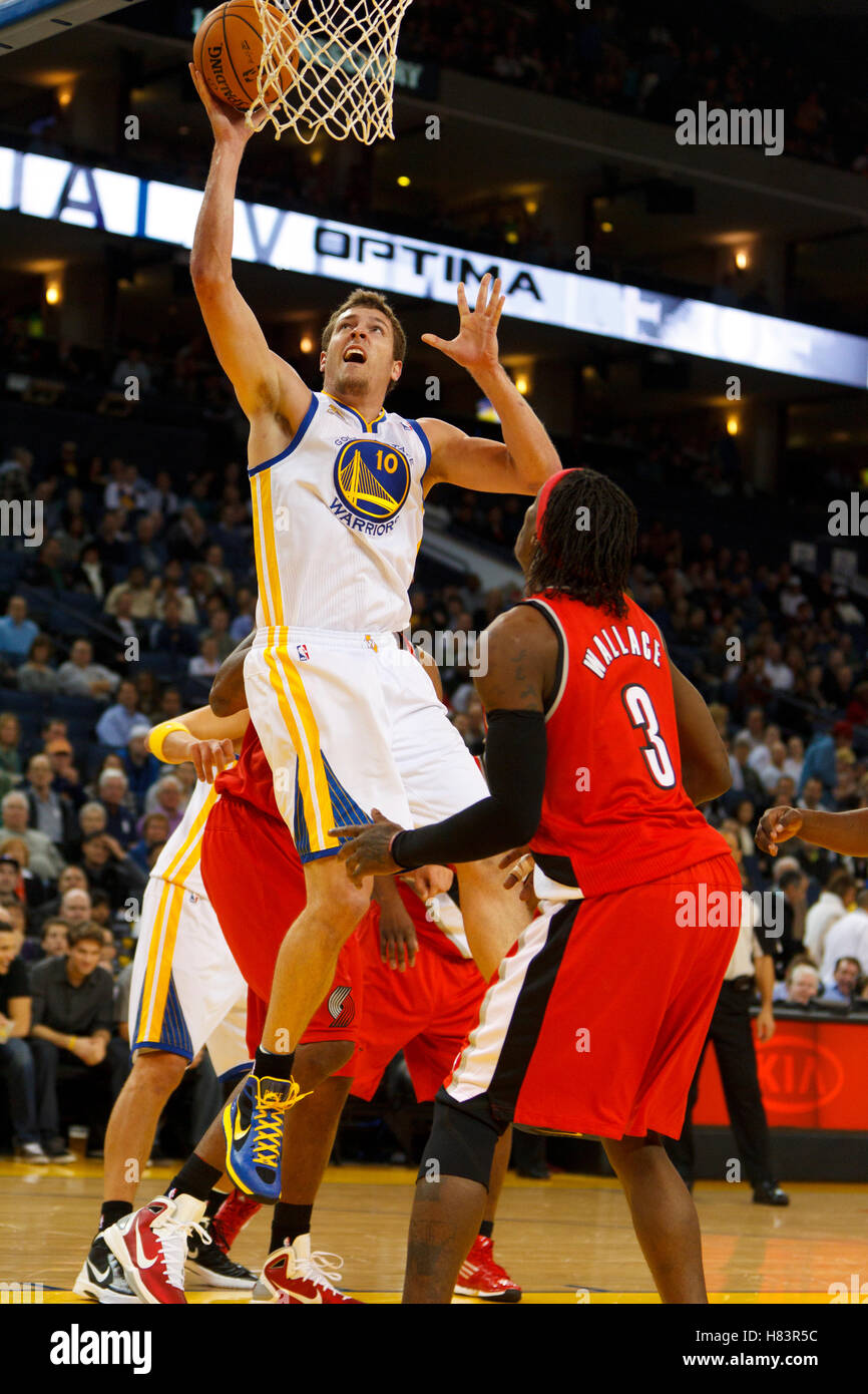 Jan 25, 2012; Oakland, CA, USA; Golden State Warriors power forward David Lee (10) shoots past Portland Trail Blazers small forward Gerald Wallace (3) during the first quarter at Oracle Arena. Stock Photo