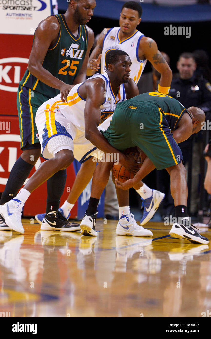 Feb 2, 2012; Oakland, CA, USA; Golden State Warriors power forward Ekpe Udoh (20) grabs the ball between the legs of Utah Jazz point guard Jamaal Tinsley (6) during the fourth quarter at Oracle Arena. Golden State defeated Utah 119-101. Stock Photo