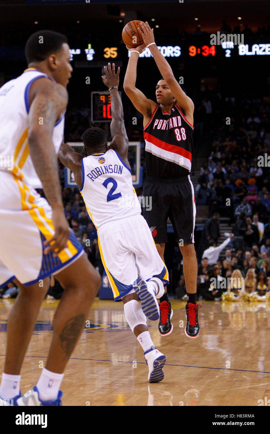 Feb 15, 2012; Oakland, CA, USA; Portland Trail Blazers small forward Nicolas Batum (88) shoots over Golden State Warriors point guard Nate Robinson (2) during the second quarter at Oracle Arena. Stock Photo