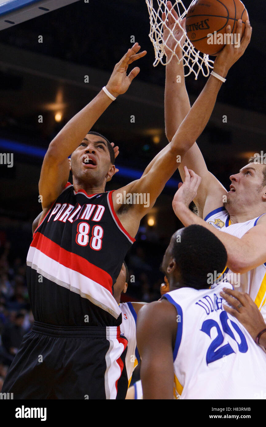 Feb 15, 2012; Oakland, CA, USA; Portland Trail Blazers small forward Nicolas Batum (88) shoots past Golden State Warriors power forward David Lee (right) and power forward Ekpe Udoh (20) during the second quarter at Oracle Arena. Stock Photo