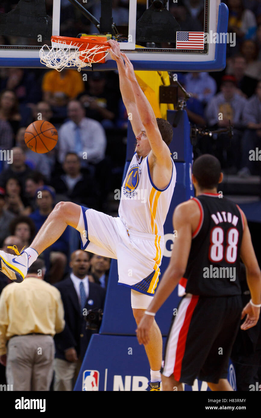 Feb 15, 2012; Oakland, CA, USA; Golden State Warriors power forward David Lee (10) dunks in front of Portland Trail Blazers small forward Nicolas Batum (88) during the second quarter at Oracle Arena. Stock Photo