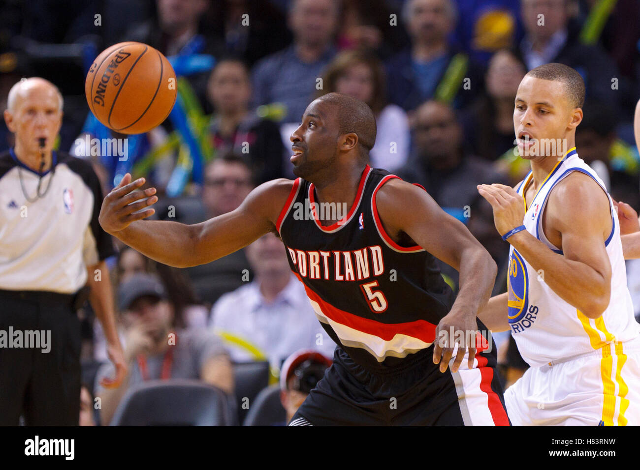 Feb 15, 2012; Oakland, CA, USA; Portland Trail Blazers point guard Raymond Felton (5) loses control of the ball in front of Golden State Warriors point guard Stephen Curry (30) during the third quarter at Oracle Arena. Portland defeated Golden State 93-91 Stock Photo