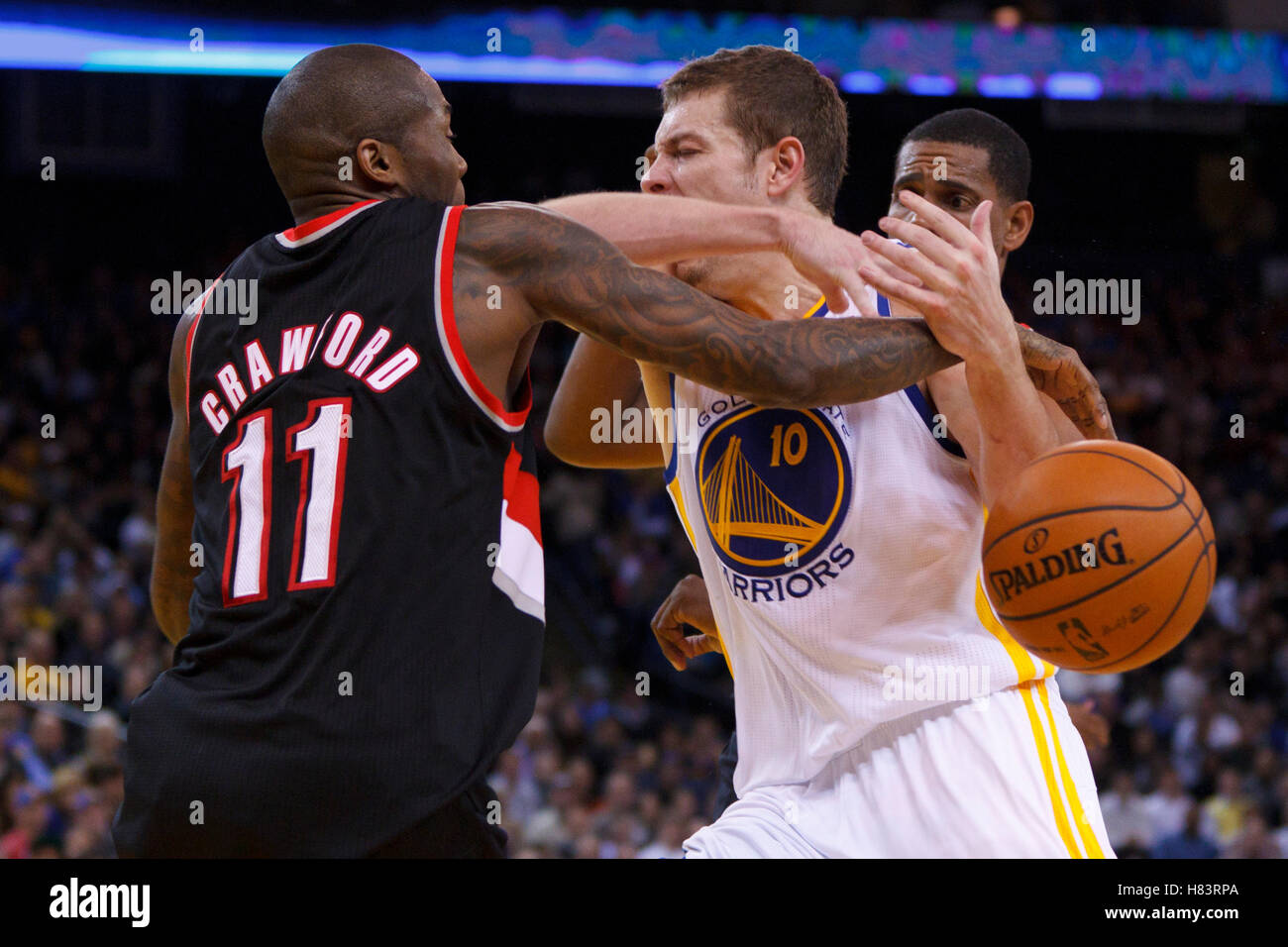 Feb 15, 2012; Oakland, CA, USA; Golden State Warriors power forward David Lee (10) is fouled by Portland Trail Blazers guard Jamal Crawford (11) during the fourth quarter at Oracle Arena. Portland defeated Golden State 93-91. Stock Photo