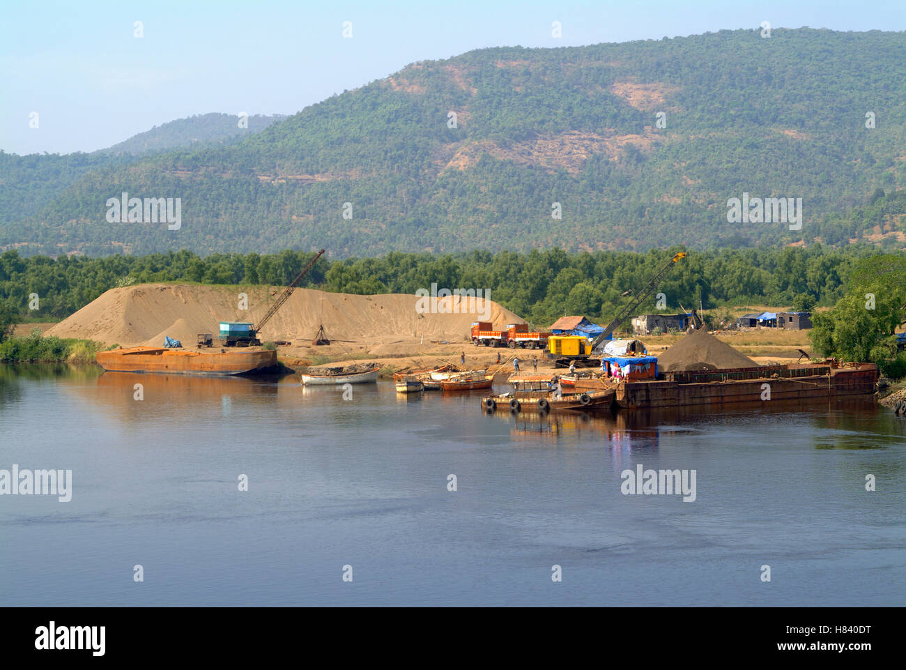 Sand mining. Barges and small boats used for transport Stock Photo