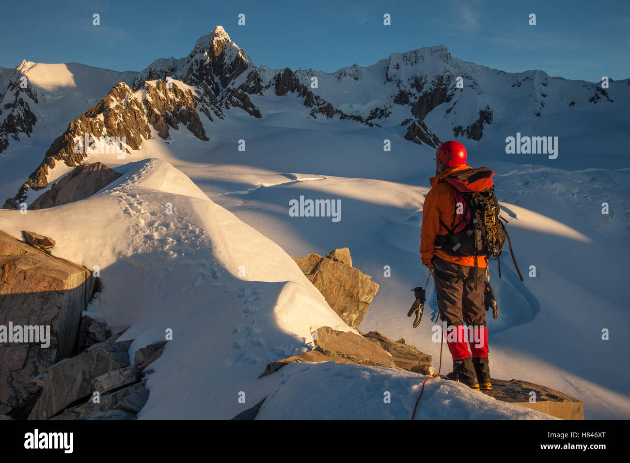 Climber near Pioneer Hut with Douglas Peak and Fox Glacier, Westland