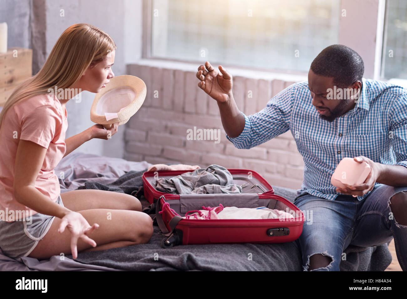 Young couple arguing and preparing for vacation Stock Photo