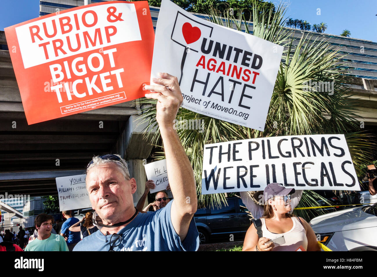 Miami Florida,protesters,signs,protest,2016 presidential campaign,Rubio Trump,MoveOn.org,immigration,man men male,woman female women,holding,FL1609250 Stock Photo