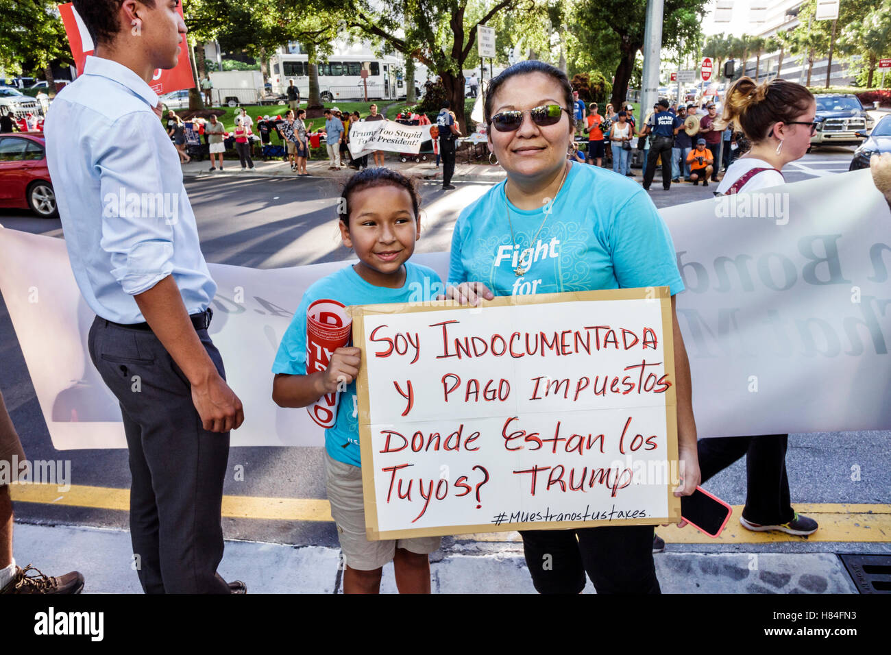 Miami Florida,protesters,signs,Spanish English,protest,2016 presidential campaign,Trump,immigration,undocumented,taxes,Hispanic woman female women,mot Stock Photo