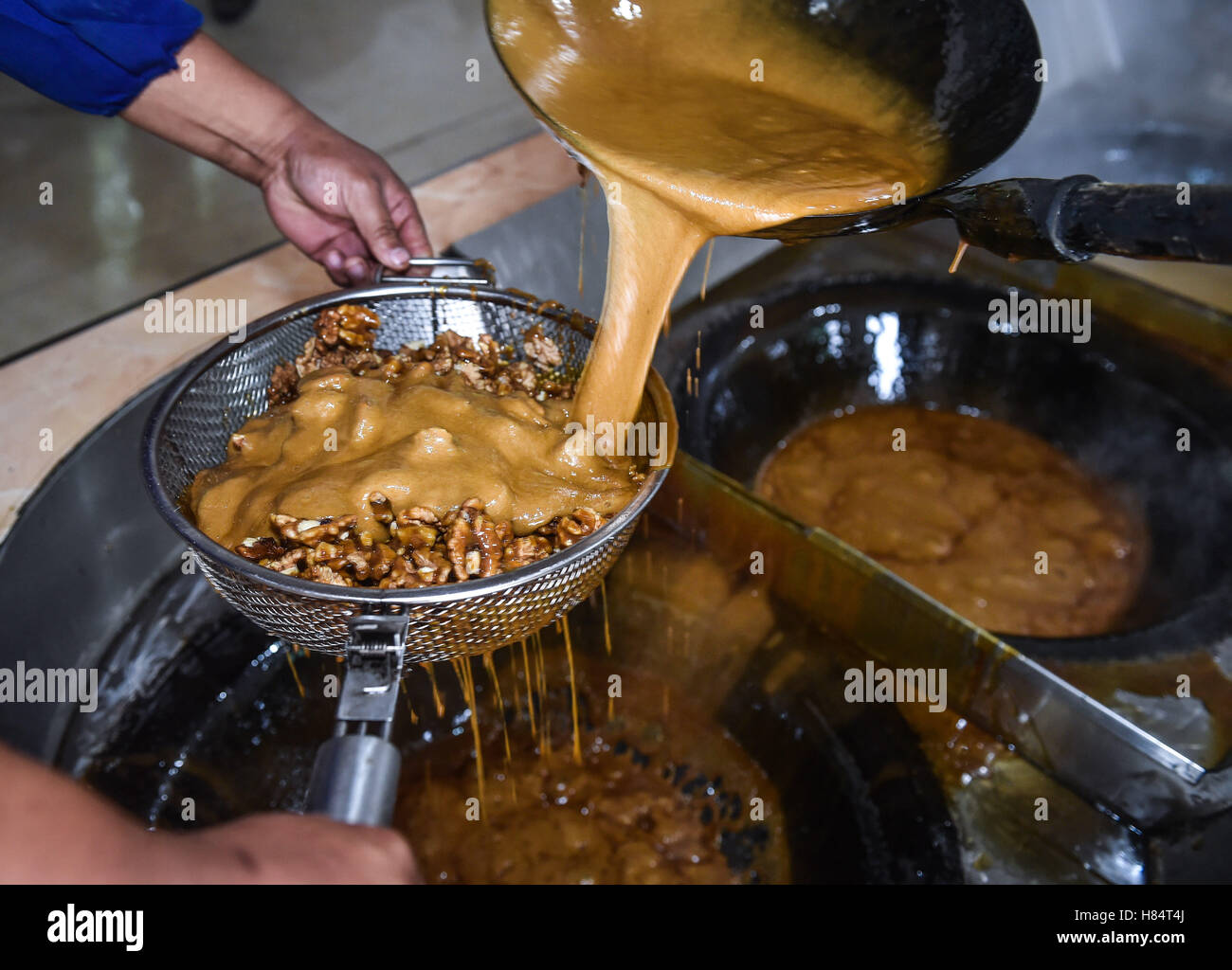 Yiwu, China's Zhejiang Province. 9th Nov, 2016. A worker pours boiled ...