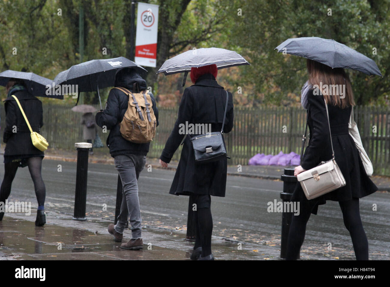 North London, UK. 9th Nov, 2016. UK Weather People sheltering under umbrellas on a wet rainy