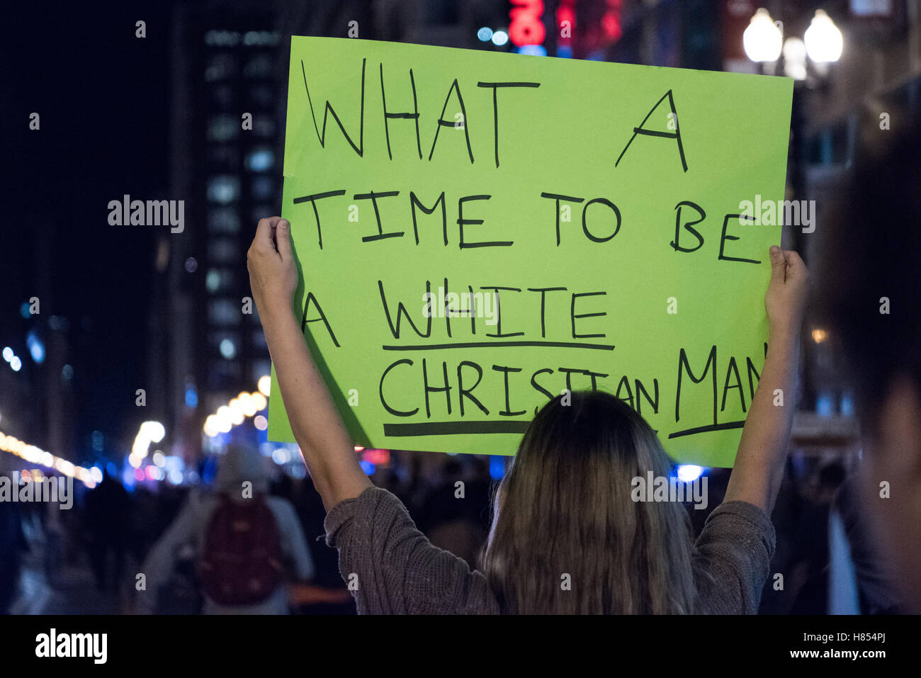 Chicago, Illinois, USA. 9th November, 2016. Anti Trump protester in Chicago holding a sign reading 'What a time to be a White Christian Man' Credit:  Caleb Hughes/Alamy Live News. Stock Photo