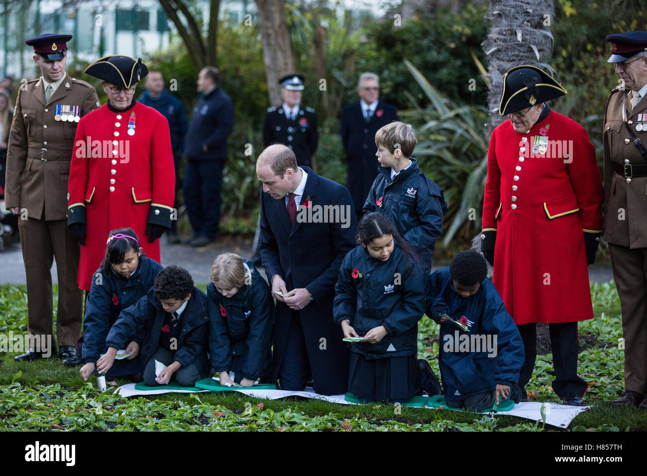 London, UK. 10th November, 2016. The Duke of Cambridge plants poppies with schoolchildren during a visit to Kensington Memorial Park as President of Fields in Trust to officially mark the dedication of the park by the Royal Borough of Kensington and Chelsea to the Centenary Fields programme. Centenary Fields honours the memory of the millions who lost their lives during the First World War by securing and protecting outdoor recreational space in perpetuity for the benefit of future generations. Stock Photo
