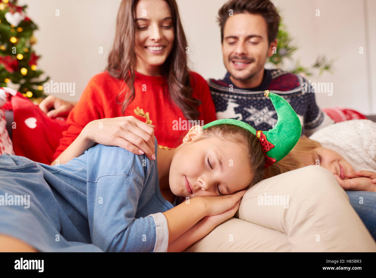Kids sleeping on the knee of parents Stock Photo Alamy