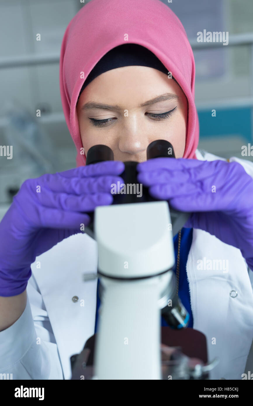 muslim lab worker with hijab or researcher doing an analysis in ...