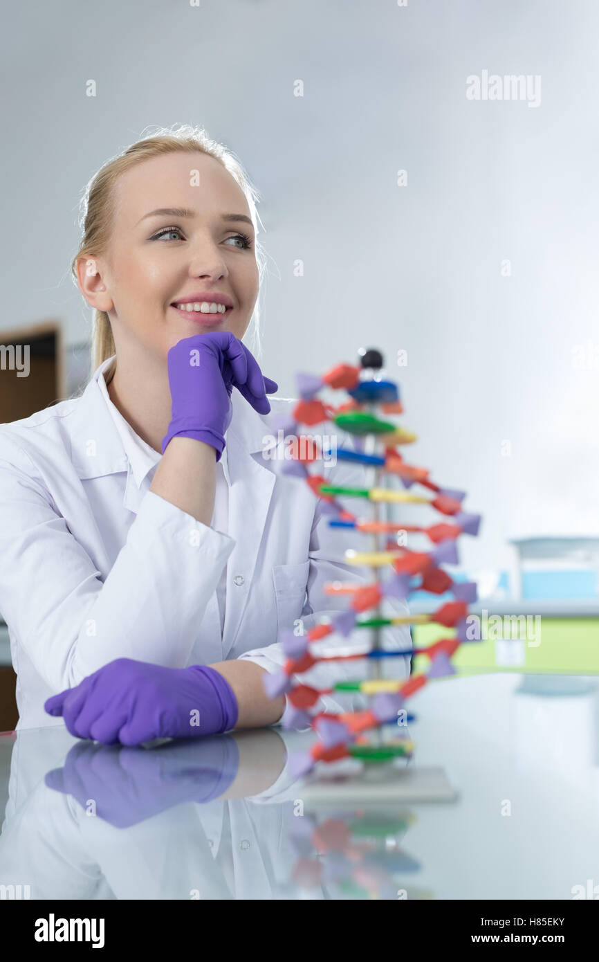 Woman scientist holding DNA molecule Stock Photo