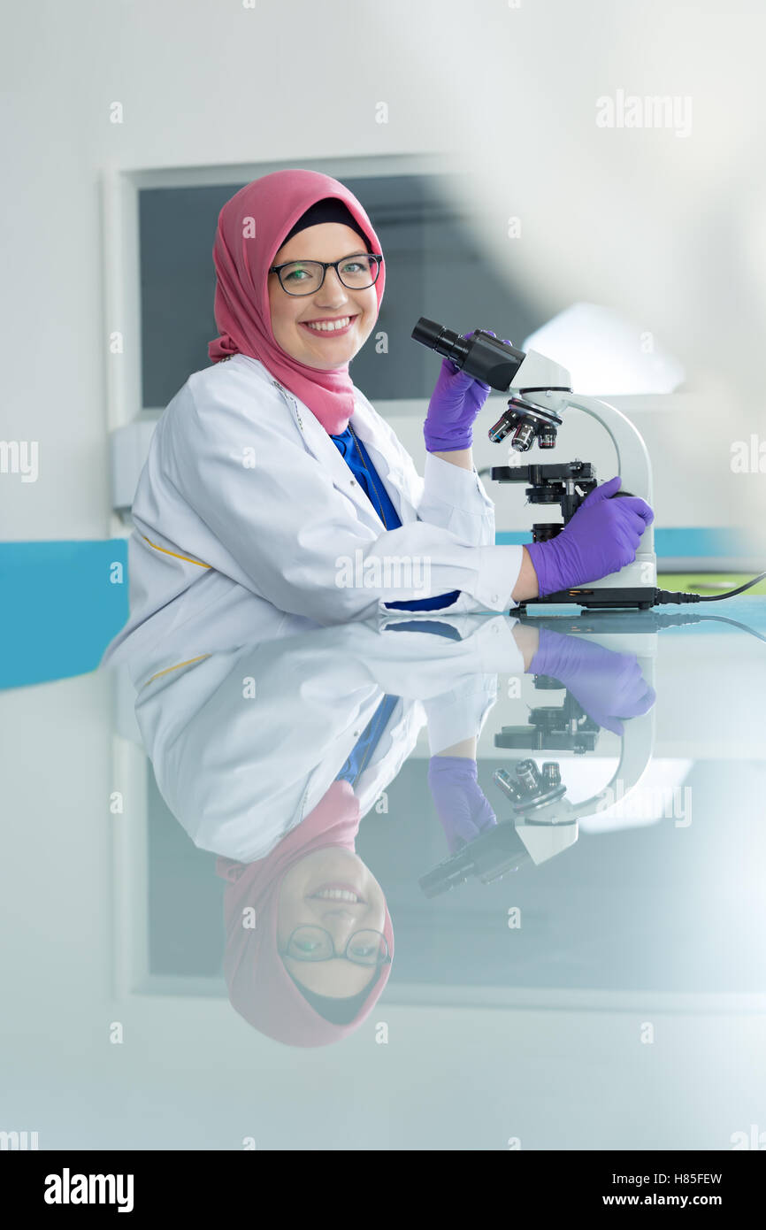 muslim lab worker with hijab or researcher doing an analysis in ...